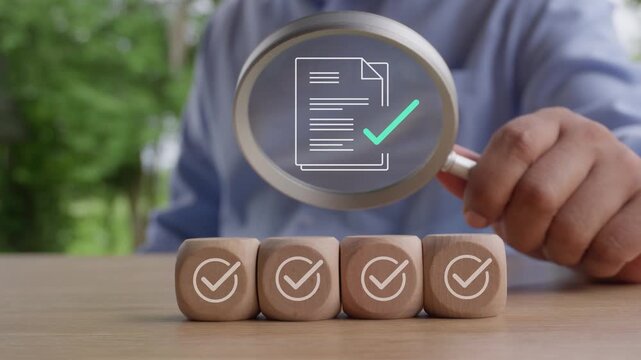 Business hand using magnifying glass to inspect document and checklist icon on wood cube, sequential verification marks, quality assurance, compliance audit, document validation, inspection process