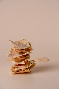 A stack of Armenian lavash chips on a beige background, copy space.