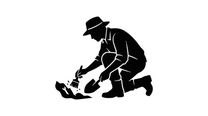 Obraz premium Man kneeling down to work on shoes.