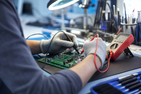 Repair Specialist Testing a Restored Circuit Board