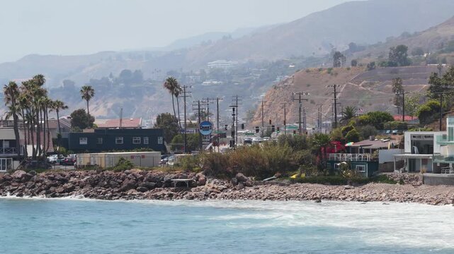 Scenic Pacific Coast Highway passing through Malibu, California with oceanfront real estate, sandy beaches, luxury properties nestled against rolling coastal hills. 02,02,2026, Malibu, USA, 
