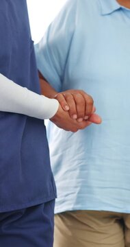 Nurse, senior and holding hands with patient for mobility, walking aid or assisted living in home. People, healthcare worker or caregiver helping person with a disability for elderly care or recovery
