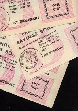 A montage of vintage Premium Bonds from the United kingdom on a black background.