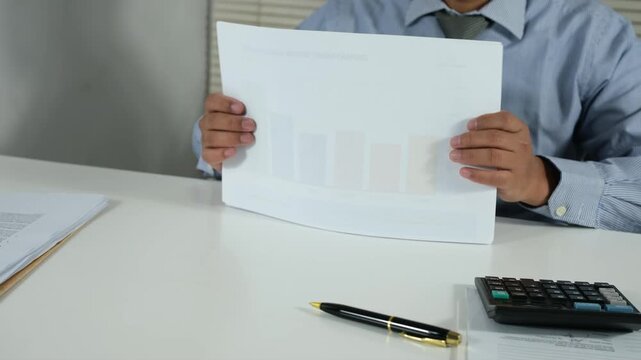 Office staff tidy up documents on their desks after work hours. The concept of neatness and cleanliness in the work environment.