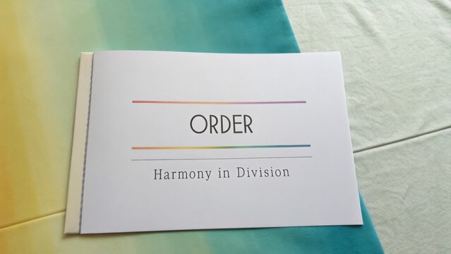 Artistic Representation of a Book Cover Featuring the Word Order with the Subtitle Harmony in Division on a Colorful Background