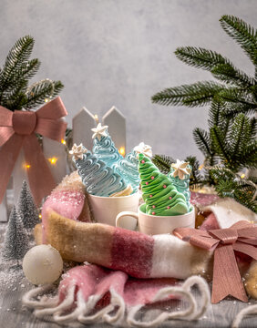 Meringue christmas trees in mugs with festive decor