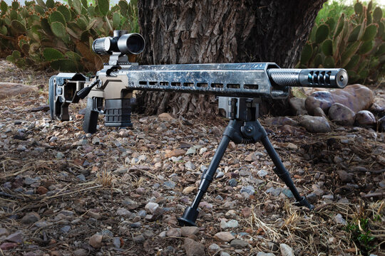 Bipod below a bolt action rifle iand magnified sight in the desert southwest