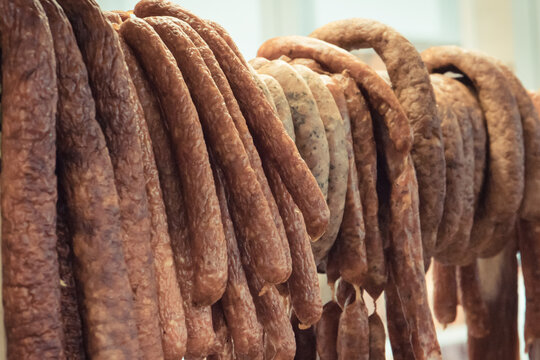 Fresh prepared smoked sausages with spices on market stall