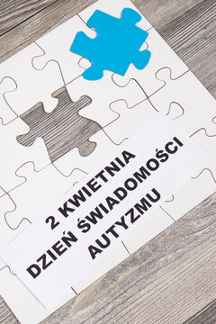 White and blue puzzle. Polish inscription 2 April Autism Awareness Day. Symbol of Autism Spectrum Disorder