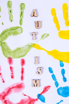 Kids handprint made of paint on white background. Autism spectrum disorder