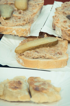 Fresh homemade dumplings and portion of wheat or rye bread with lard and pickled cucumber. Traditional polish food