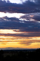 Fototapeta premium Beautiful pastel cloudy sunset. Bright orange, yellow and purple colors real sunset sky, colorful sky during sunset or sunrise.
