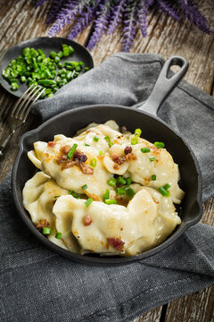 Fried dumplings (pierogi) with meat filling sprinkled with greaves.