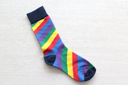 Colorful, mismatched socks ready to be worn as a symbol of inclusion, diversity, and acceptance to promote respect for people with Down syndrome