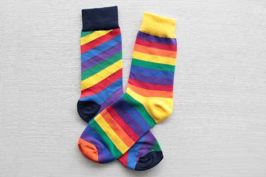 Colorful, mismatched socks ready to be worn as a symbol of inclusion, diversity, and acceptance to promote respect for people with Down syndrome