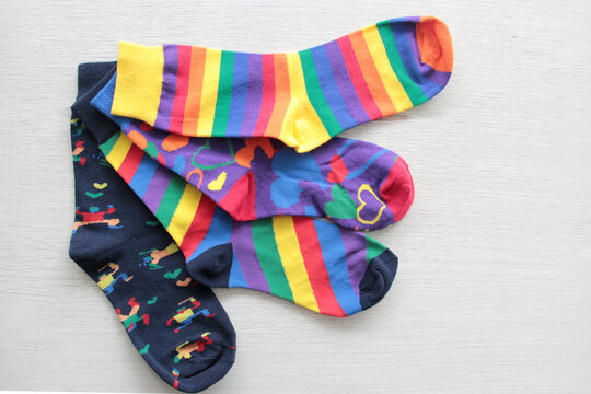 Colorful, mismatched socks ready to be worn as a symbol of inclusion, diversity, and acceptance to promote respect for people with Down syndrome