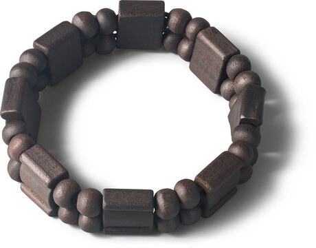 black wooden bead bracelet isolated white background, round and rectangular carved wood pieces elastic band jewelry in close-up view