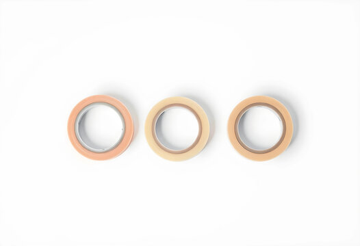 Three rolls of beige adhesive tape on white background