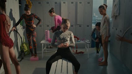 Obraz premium Teenage Rhythmic Gymnast Dealing With Severe Stage Fright and Psychological Pressure Before Tournament. Girl Turns on Playlist on Smartphone, Inserts Earphones, Shuts Eyes Tightly to Battle Anxiety.