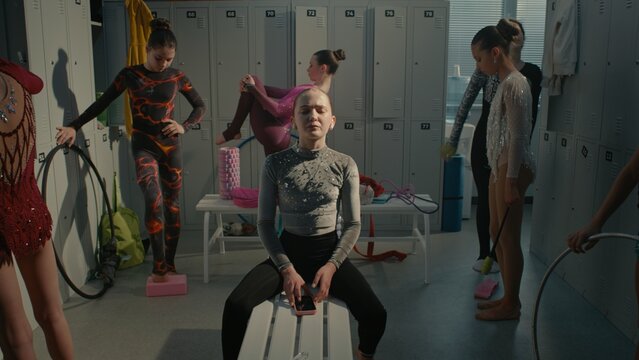 Teenage Rhythmic Gymnast Dealing With Severe Stage Fright and Psychological Pressure Before Tournament. Girl Turns on Playlist on Smartphone, Inserts Earphones, Shuts Eyes Tightly to Battle Anxiety.