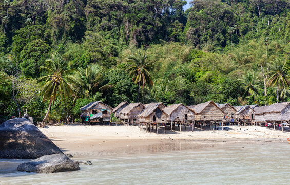 Moken Sea Gypsy Village on Koh Surin, Thailand. Tropical coastal setting with traditional huts. Andaman Sea backdrop.