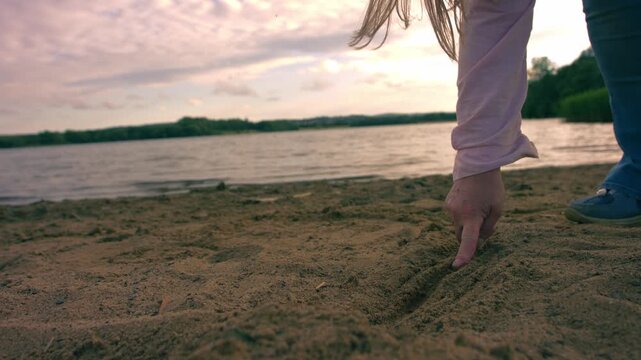 Woman drawing a line in the sand at beach