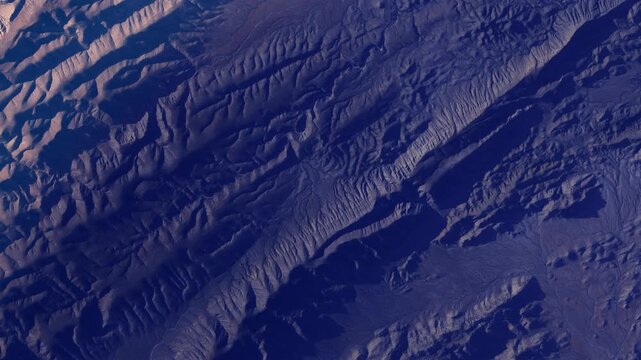 Sunrise timelapse flying over red desert mountains and rocky landscape from space based on Nasa imagery