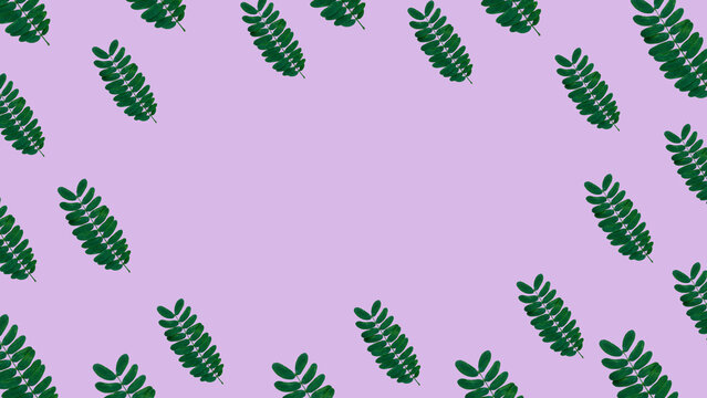 Aesthetic seamless scatter pattern of green leaves framing a blank center over a smooth pastel purple background.