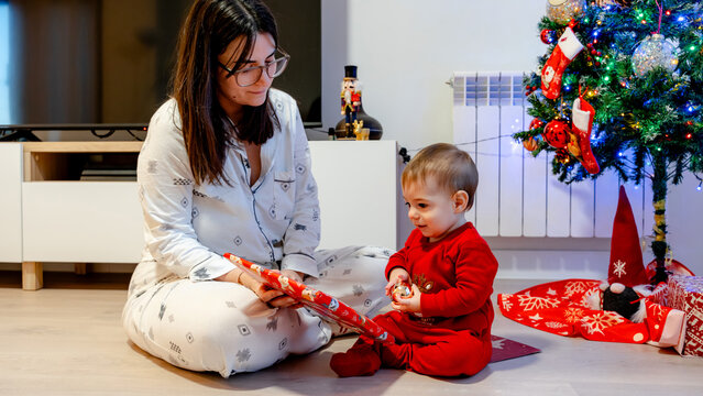 Mother and baby enjoy Christmas morning gifts