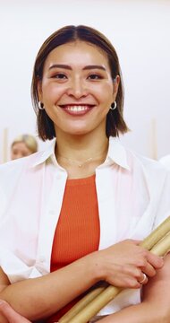 Asian woman, face and arms crossed with drum sticks in class for taiko tradition, culture or practice. Portrait, Japanese musician and person with pride for music lesson, sound or percussion art
