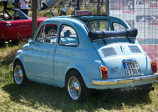 Garching near Munich, Germany - Old Timers Show: vintage blue Fiat 500 with open roof, rear view