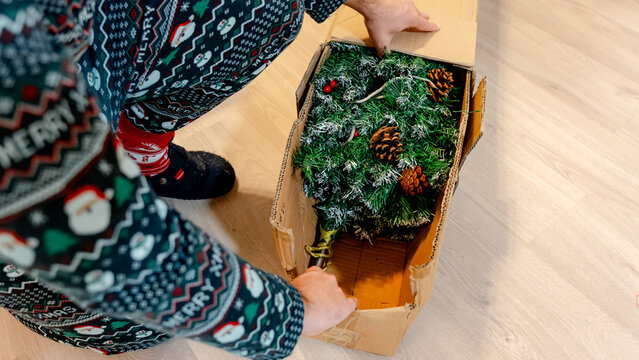 Preparing a Christmas tree in festive pajamas