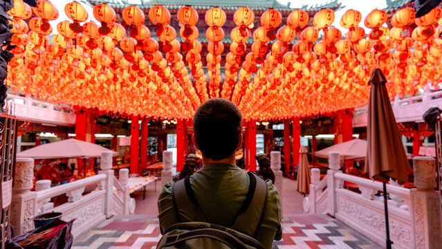 Tourist admiring lanterns in Sunfong Temple courtyard