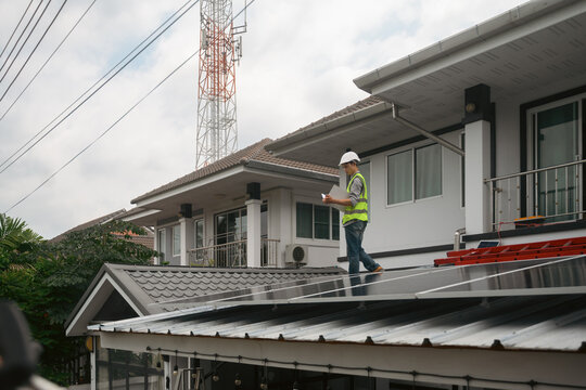 Engineer Inspecting Solar Panel Installation on Residential Home Rooftop