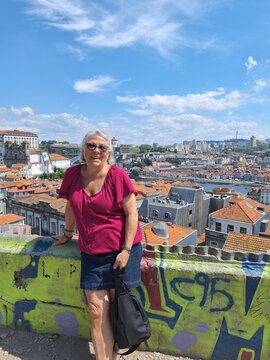 Retired woman taking a picture in porto, portugal