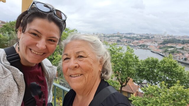 Mother and daughter taking a selfie on vacation in porto, portugal