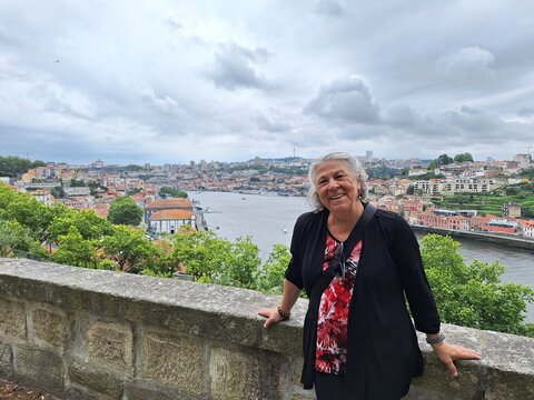 Retired woman taking a picture in porto, portugal