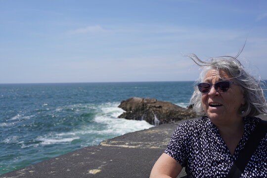 Retired woman taking a picture in porto, portugal