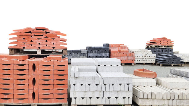 Stacked concrete curbstones on pallets.