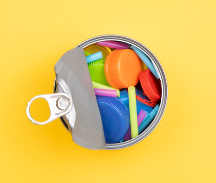 Plastic waste in an open tin. Canned food containing plastic concept
