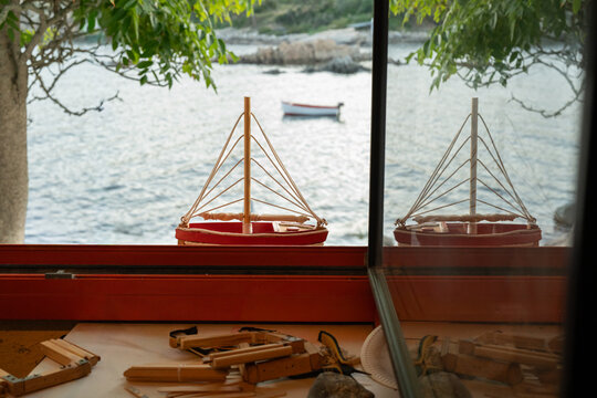 Model sailboat by window overlooking sea in Palamos