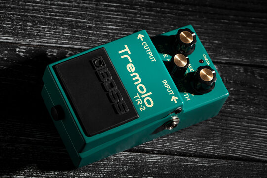 boss tremolo guitar effects pedal on black wood background