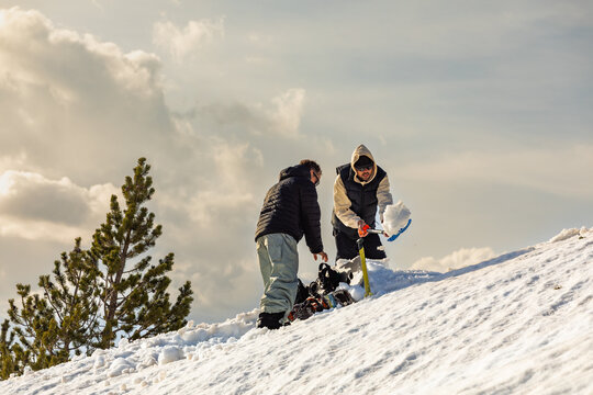 Snowboarding preparation in winter mountain setting