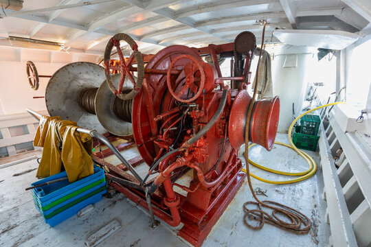 Industrial ship winch with steel cable on working deck