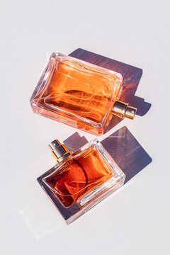 Elegant glass perfume bottles casting shadows