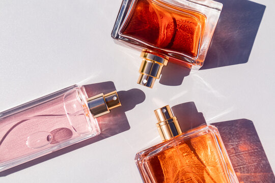 Elegant perfume bottles casting soft shadows