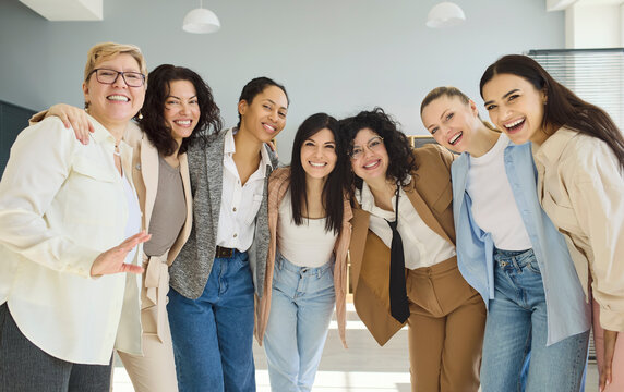 Women team portrait smiling, showing leadership and teamwork. Colleagues in a bright office unite with confidence, celebrating diversity and support. Female leadership and teamwork empowerment.