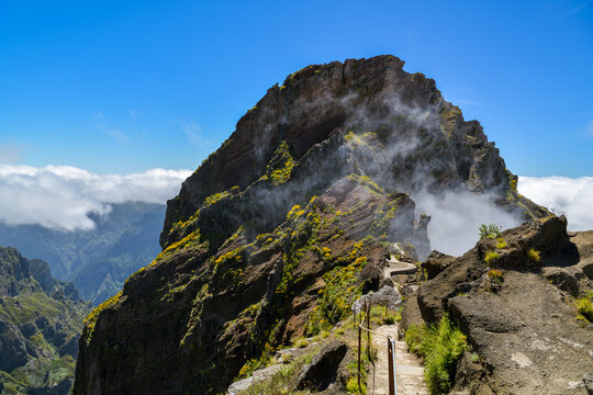 Stone hiking path descending along a rocky peak