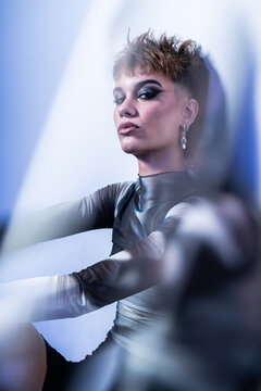 Young woman fashion model posing in studio with edgy style