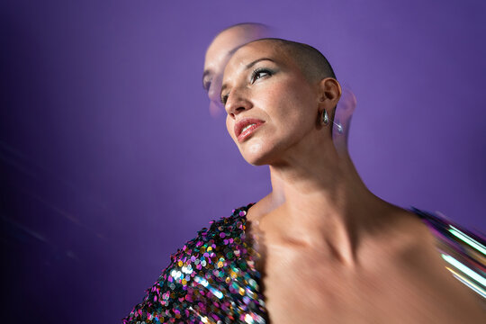 Middle aged shaved head fashion model in purple studio
